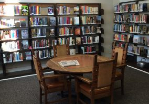 table and bookcases in the library